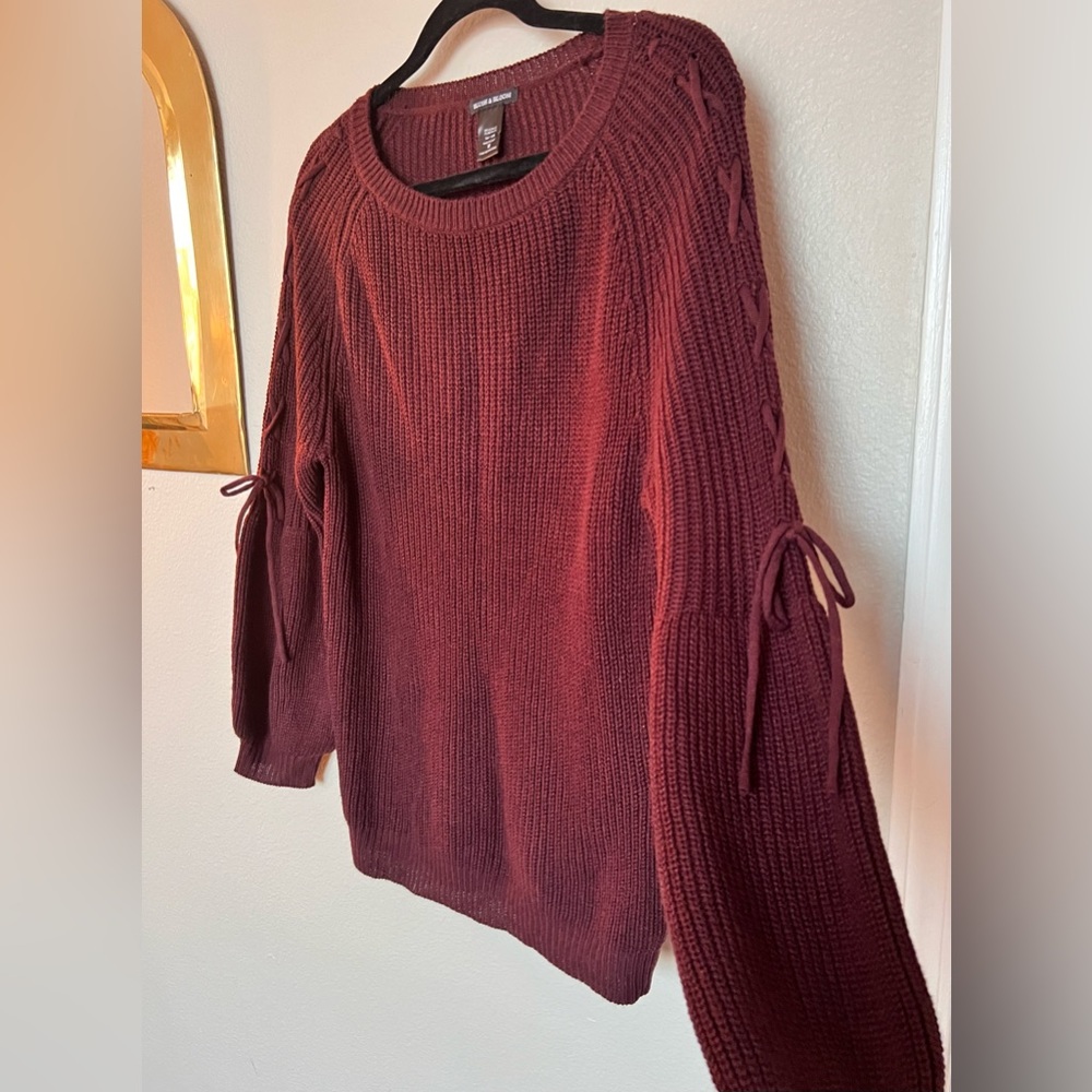 Cute maroon sweater with braided detail on the sleeves, bishop sleeves.